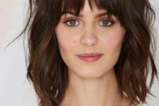 a dark brunette long bob with bottleneck bangs, waves and a lot of dimension is a super chic and cool idea