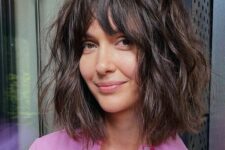 a dark brunette shaggy long bob with a mesys and thick fringe and a lot of messy waves is a lovely idea