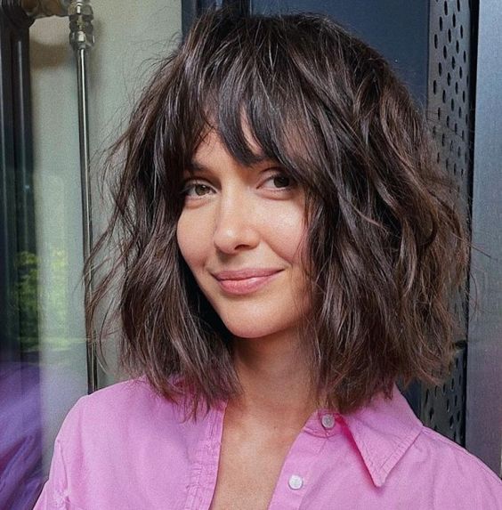 a dark brunette shaggy long bob with a mesys and thick fringe and a lot of messy waves is a lovely idea