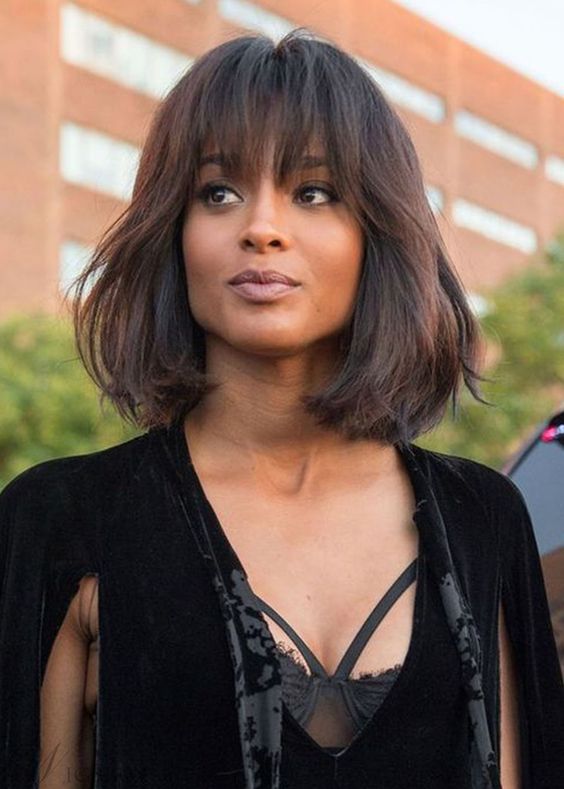 a fantastic deep brown long bob with texture and overgrown bangs to make a girlish statement