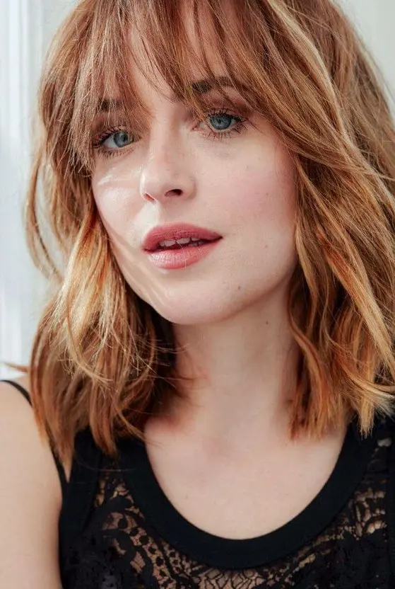a ginger outgrown textured bob with blonde highlights and outgrown wispy bangs is a bold and catchy solution