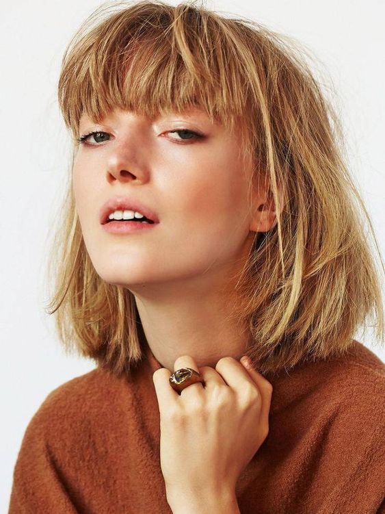 a ginger to blonde long bob with a thick fringe and a lot of volume is a cool idea with a lot of bright color