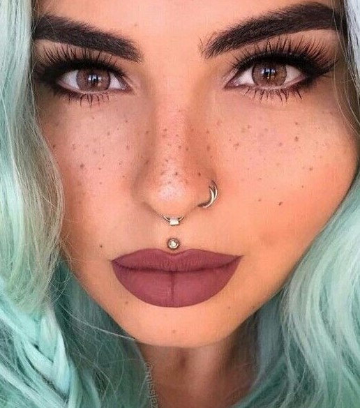 a gorgeous double nose hoop piercing and an additional septum hoop for a super rebellious look