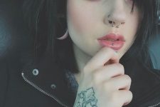 a hoop in the nostril and a barbell in the septum for a statement and bold look