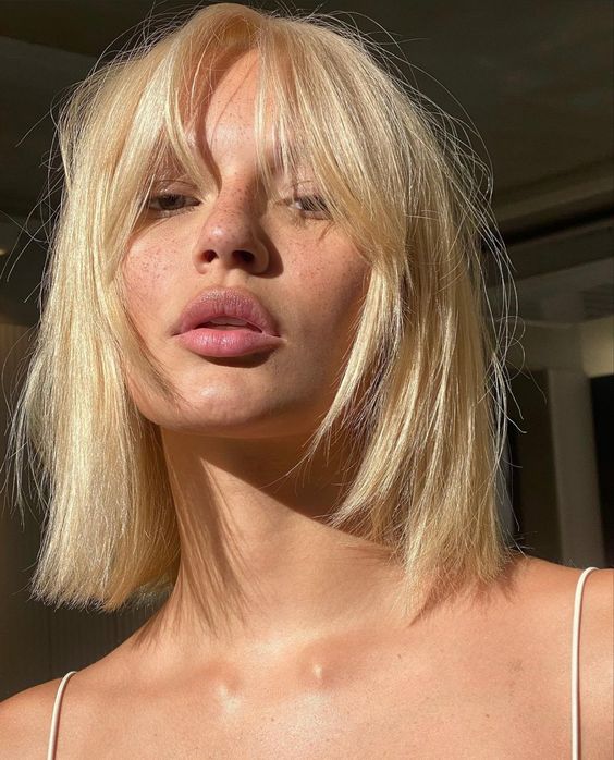 a long blonde bob with layers and bottleneck bangs is a catchy and bright idea to rock