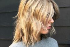 a messy blonde wavy long bob with curtain bangs is a chic and relaxed idea to rock any time