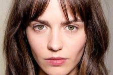 a messy layered brown shoulder-length bob with highlights and bottleneck bangs is a lovely idea to wear right now