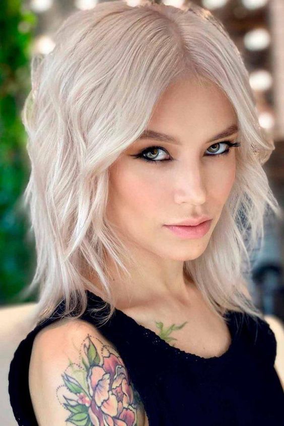 a platinum blonde long bob with side bangs and waves is a chic and bold idea, make a statement with color