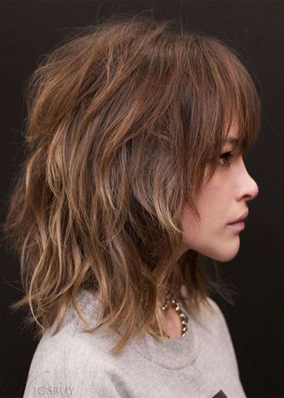 a shoulder-length layered shaggy haircut with blonde highlights and overgrown bangs is a bold and cool idea