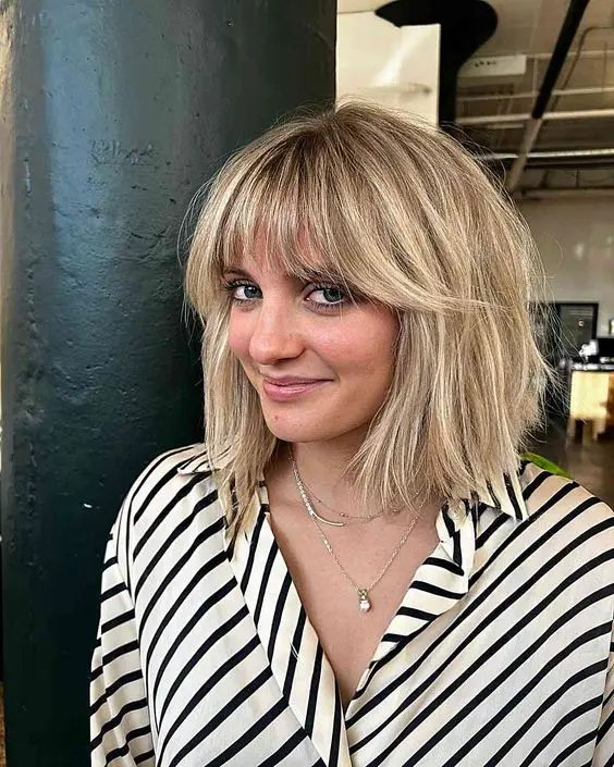 ab londe long bob with wispy bangs and messy texture is a cool and lovely solution that is effortlessly chic