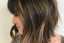 an inverted long brunette bob with caramel highlights and waves plus a fringe is a chic and stylish idea to try