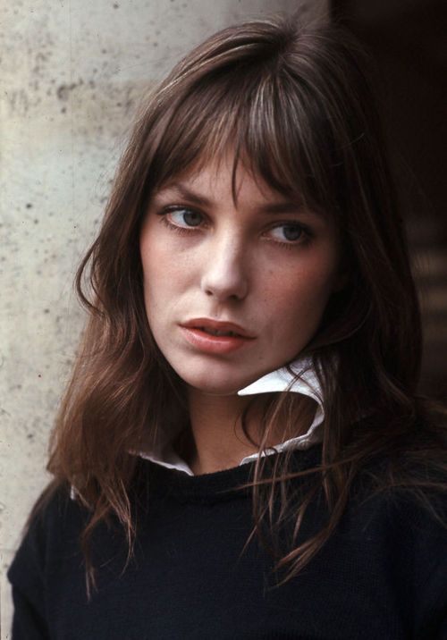 famous Jane Birkin wearing brown shoulder-length hair and wispy bangs with parting that will become her style feature
