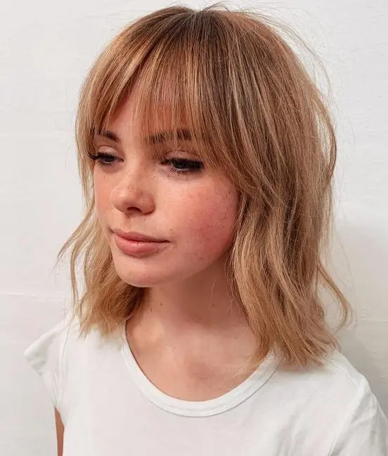 light copper hair with messy waves and bottleneck bangs is a lovely relaxed idea that shows off both color and texture