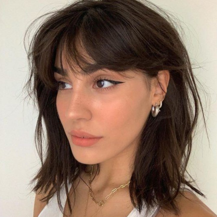 remove excess weight from thick hair by opting for this It-girl-approved haircut, messy bangs give a messy and effortlessly chic look
