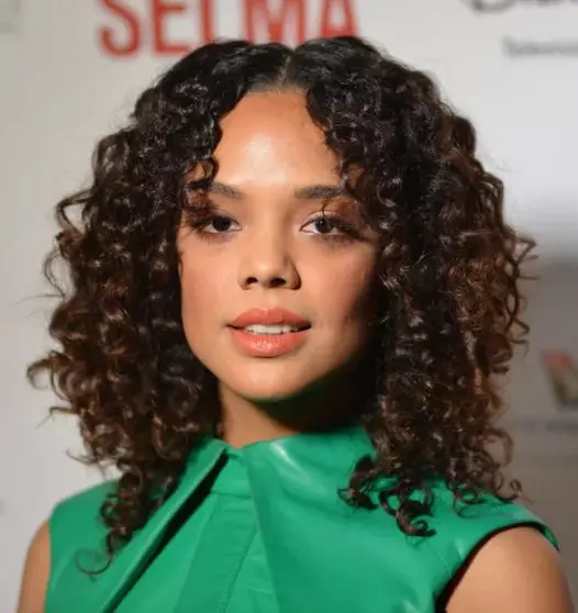 the center part is trending, for good reason and, as Tessa Thompson shows us, it can absolutely work for curly hair as well as straight
