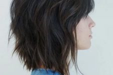 the sassy brunette bob is a modern twist on the traditional short shag haircut, wispy bangs swept to the size emphasize the eyes