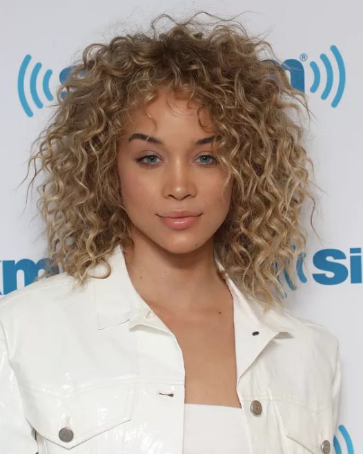 wispy blonde ringlets and lifted roots give Jasmine Sanders a cool, choppy appearance, add some grit to your curls with a texturing spray