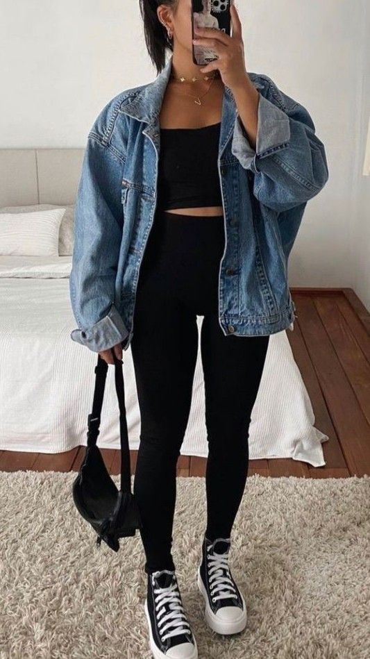 a simple and comfy sport chic outfit with a black crop top, black leggings, black high top sneakers, a blue denim jacket and a black bag