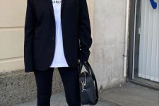07 a sport chic monochromatic look with a white tee, black leggings and a black oversized blazer, white socks and trainers, a black bag
