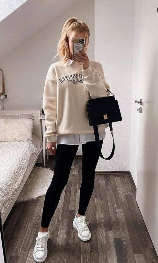 a sporty look for every day - black leggings, white sneakers, a white shirt, a tan sweatshirt and a black bag