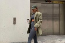 11 a spring athleisure look with a grey crop top and leggings, white trainers and socks, a green oversized blazer and a cap