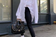 12 a very simple sport chic look with an oversized white shirt, black leggings, white trainers and socks, a black quilted bag
