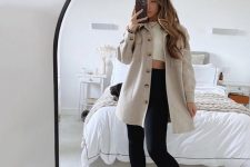 13 a white crop top, black leggings, grey trainers, a tan shirt jacket for a comfortable and chic spring look