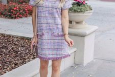 With beige leather bag and lilac short sleeved fringe mini dress