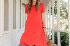 With beige straw wide brim hat, beige and orange straw rounded bag and red short sleeved knee-length dress