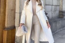 With beige turtleneck, cream belted midi coat, light gray leather bag and leather heeled boots