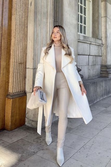 With beige turtleneck, cream belted midi coat, light gray leather bag and leather heeled boots