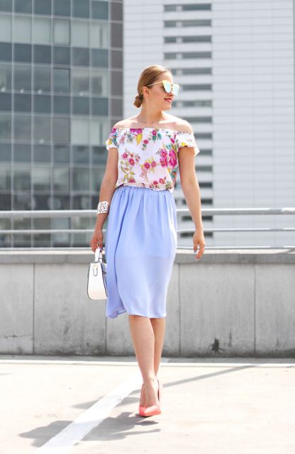 With floral printed off the shoulder top, light blue knee-length skirt, white leather bag and peach colored pumps