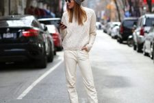 With gray hat, sunglasses, white knitted sweater and white lace up flat shoes