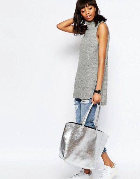 With gray long sleeveless turtleneck, distressed cuffed jeans and white and light gray sneakers
