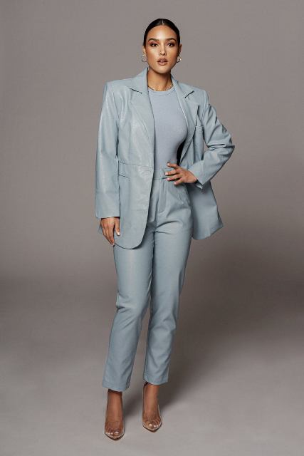 With light blue top, light blue leather blazer and transparent pumps