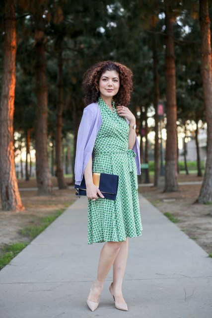 With lilac cardigan, navy blue and golden clutch and beige leather pumps