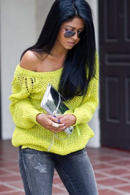 With neon one shoulder loose sweater, sunglasses and gray distressed skinny jeans