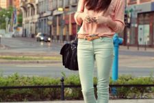 With pale pink sweater, brown leather belt, black leather bag and cobalt blue pumps