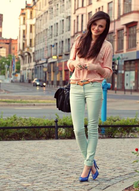 With pale pink sweater, brown leather belt, black leather bag and cobalt blue pumps