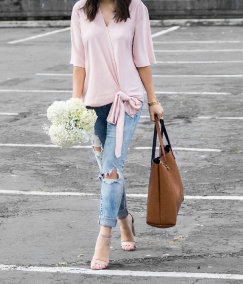 With pale pink wrap shirt, brown leather tote bag and distressed cuffed jeans