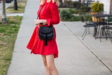 With red belted asymmetrical dress, oversized sunglasses and black tassel crossbody bag