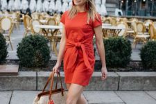 With red belted mini dress, sunglasses and beige and brown tote bag with orange and pale pink tassels