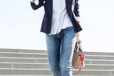 With striped button down shirt, navy blue blazer, skinny jeans, white lace up flat shoes and beige leather bag