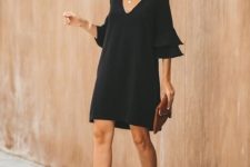 With sunglasses, black bell sleeved mini dress and brown leather clutch