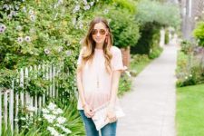 With sunglasses, white clutch, distressed skinny jeans and white sandals