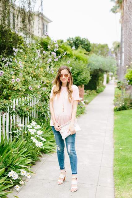 With sunglasses, white clutch, distressed skinny jeans and white sandals