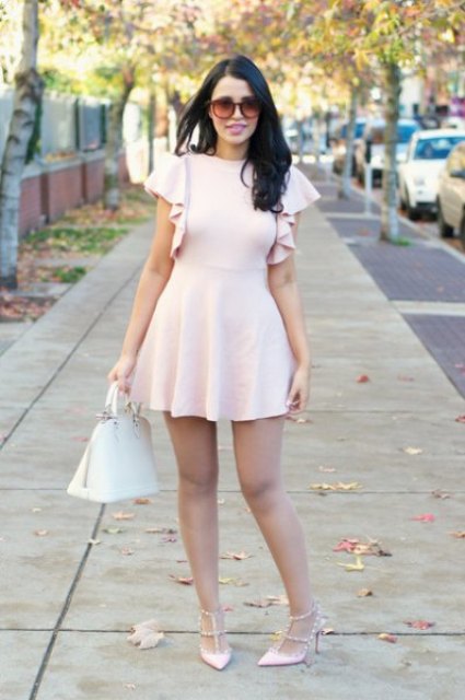 With sunglasses, white leather bag and pale pink ruffled mini dress
