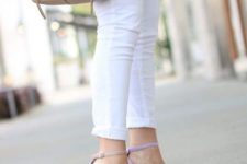 With white cuffed skinny jeans and beige leather bag