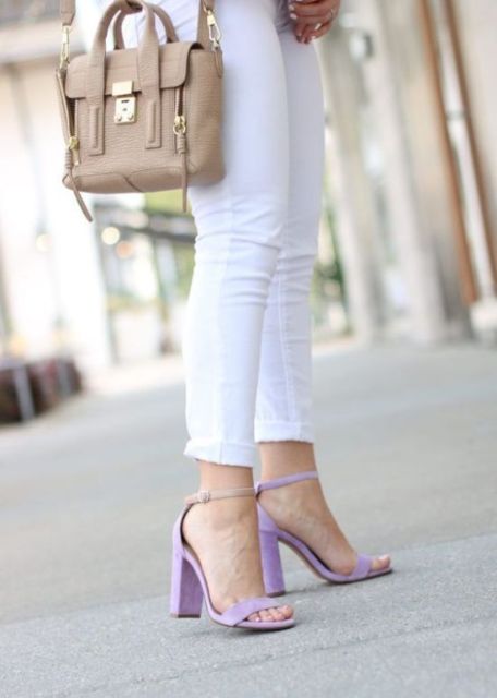 With white cuffed skinny jeans and beige leather bag