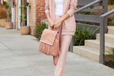 With white fitted shirt, pale pink jogger pants, white flat shoes and pale pink long jacket